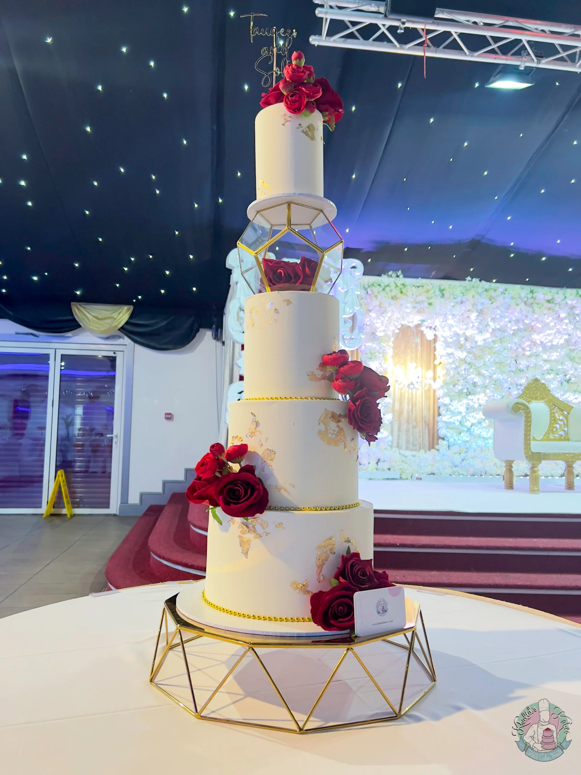 Hexagon Wedding Cake Birmingham — three tier cake with a distinctive hexagon shape, metallic leaf and flower colour accents.