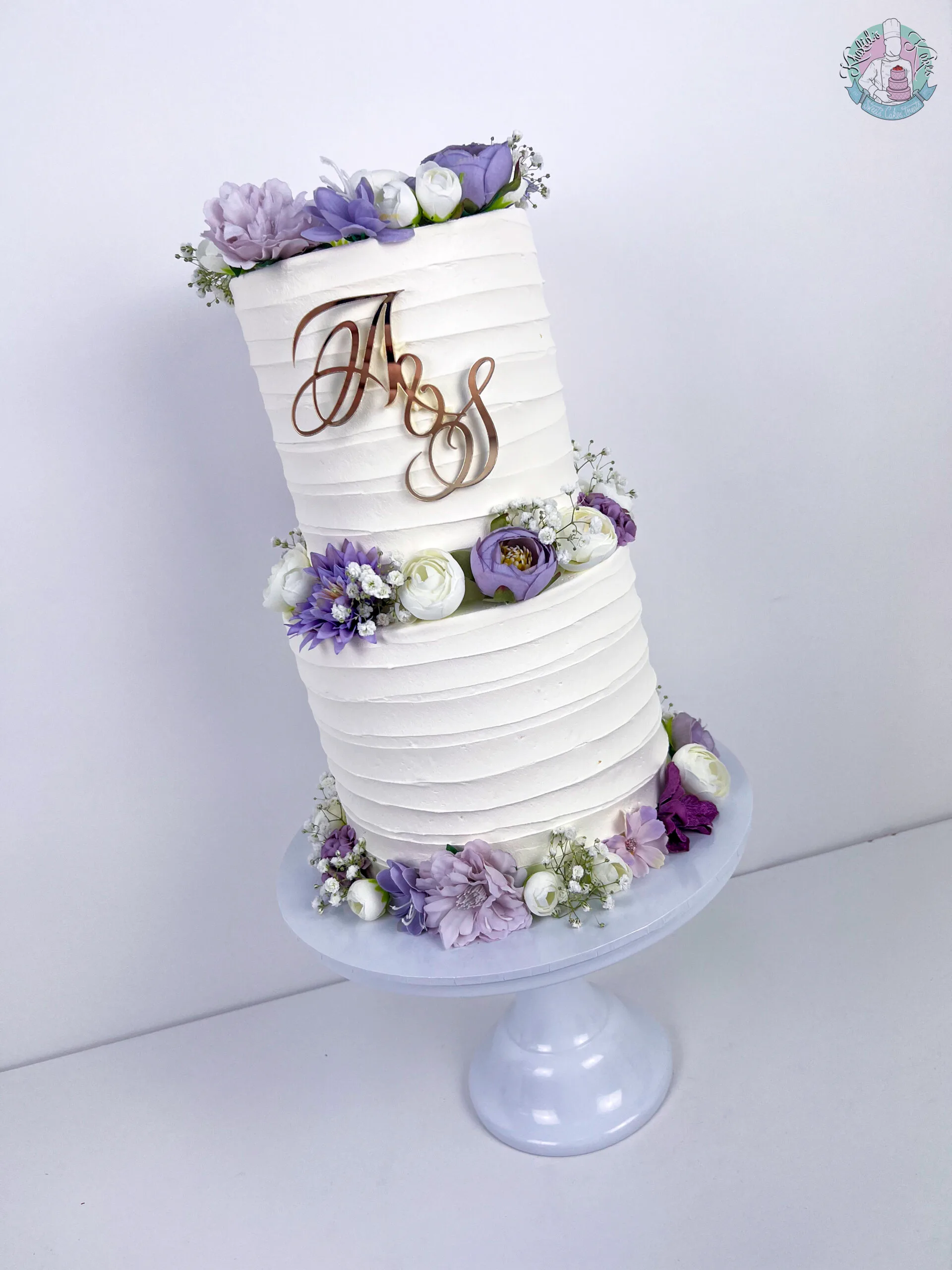 Bevelled Wedding Cake 2 Birmingham — tiered cake with smooth sculpted bevelled edges and flower colour accents.
