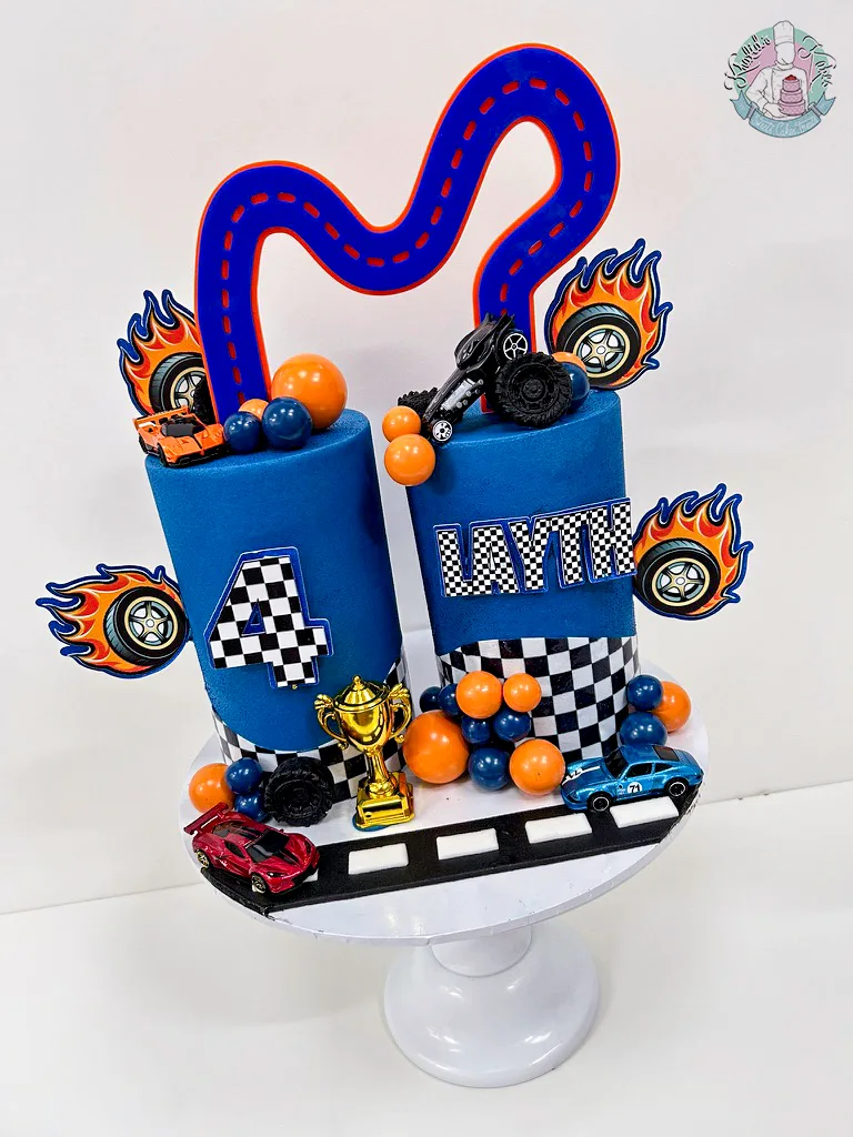 Hot Wheels Joint Cake Birmingham — children’s birthday cake with racing track and cars for two names.