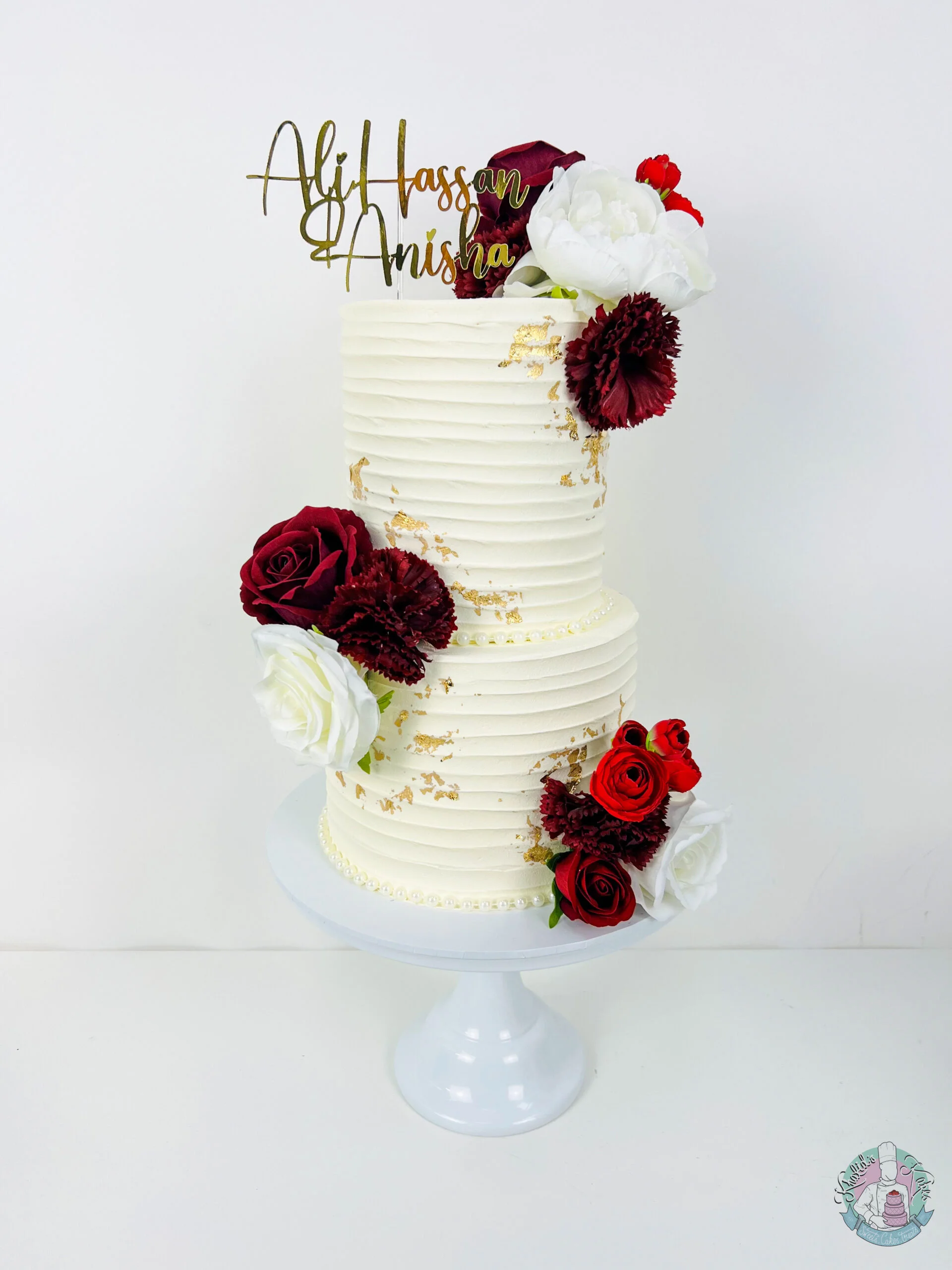 Bevelled Edge Wedding Cake Birmingham — tiered cake with crisp sculpted bevelled edges and metallic leaf accents.
