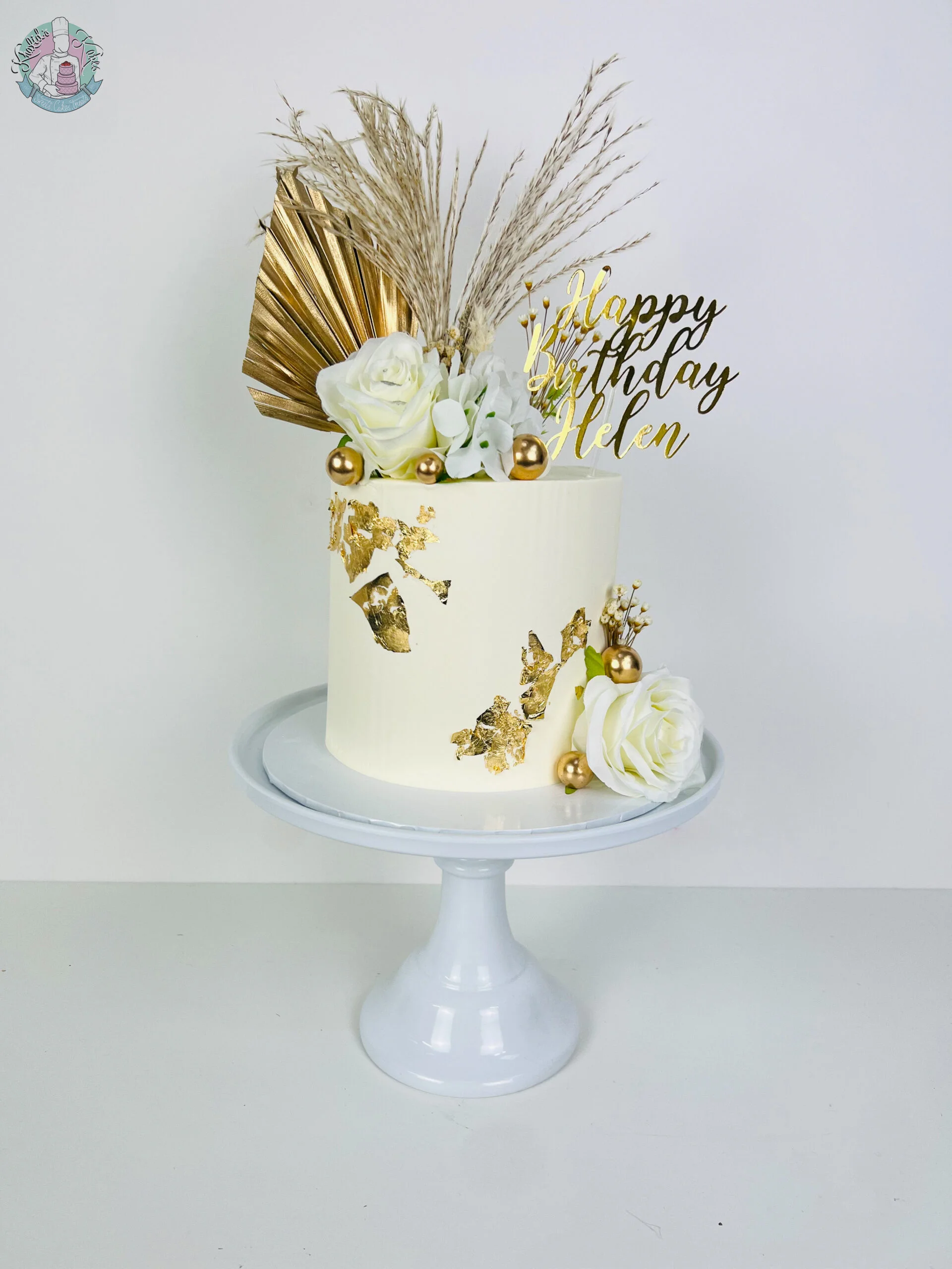 Dried Pampas Cake Birmingham, a cake styled with dried pampas, coloured flowers and metallic leaf, handmade by Khalids Kakes