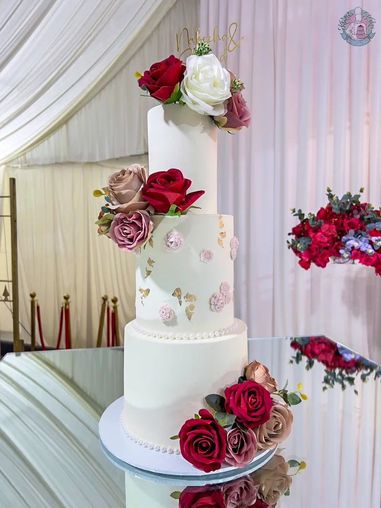 Floral Wedding Cake Birmingham — tiered cake with mini sugar florals, a pearl ribbon and custom topper.