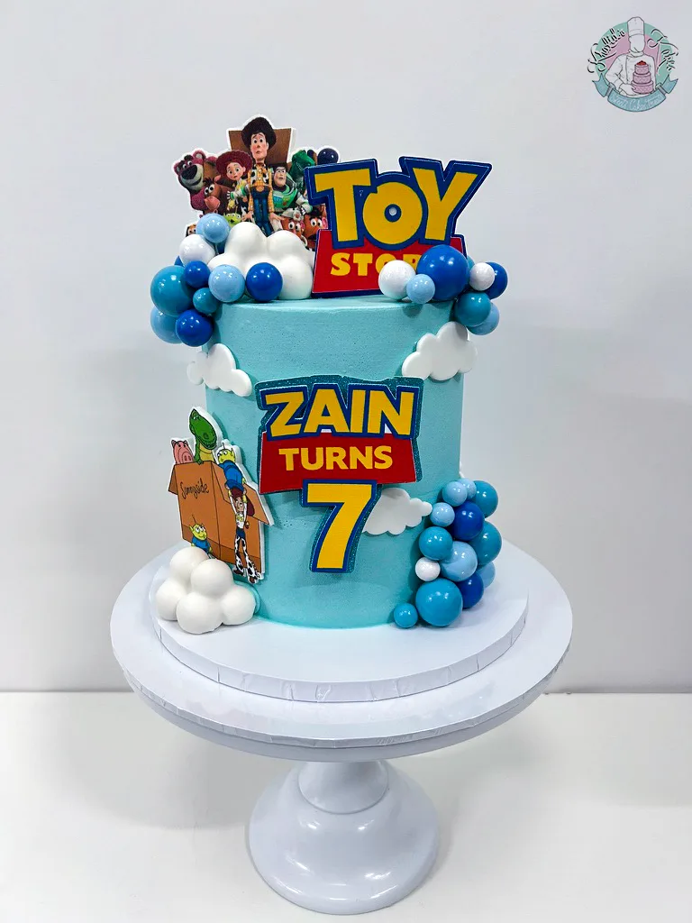 Toy Story Cake Birmingham — children’s birthday cake with Woody, Buzz and a cloud sky.