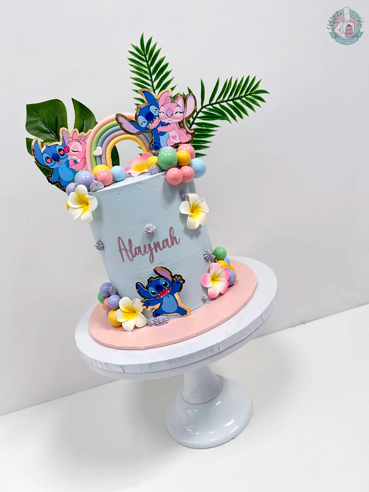 Lilo and Angel Cake Birmingham — pastel buttercream cake with Lilo and Stitch toppers and rainbow details, handmade by Khalid's Kakes