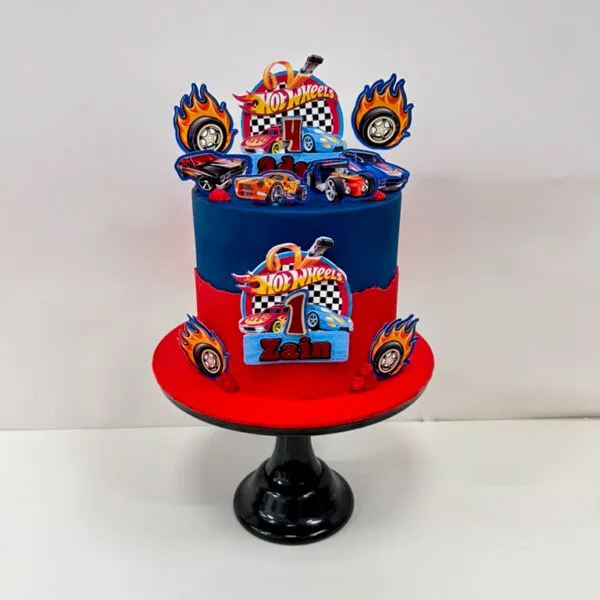 Shop 324 Hot Wheels Cake 2 Birmingham — bright red and blue racing cake with car toppers and checkered flag details, handmade by Khalid's Kakes