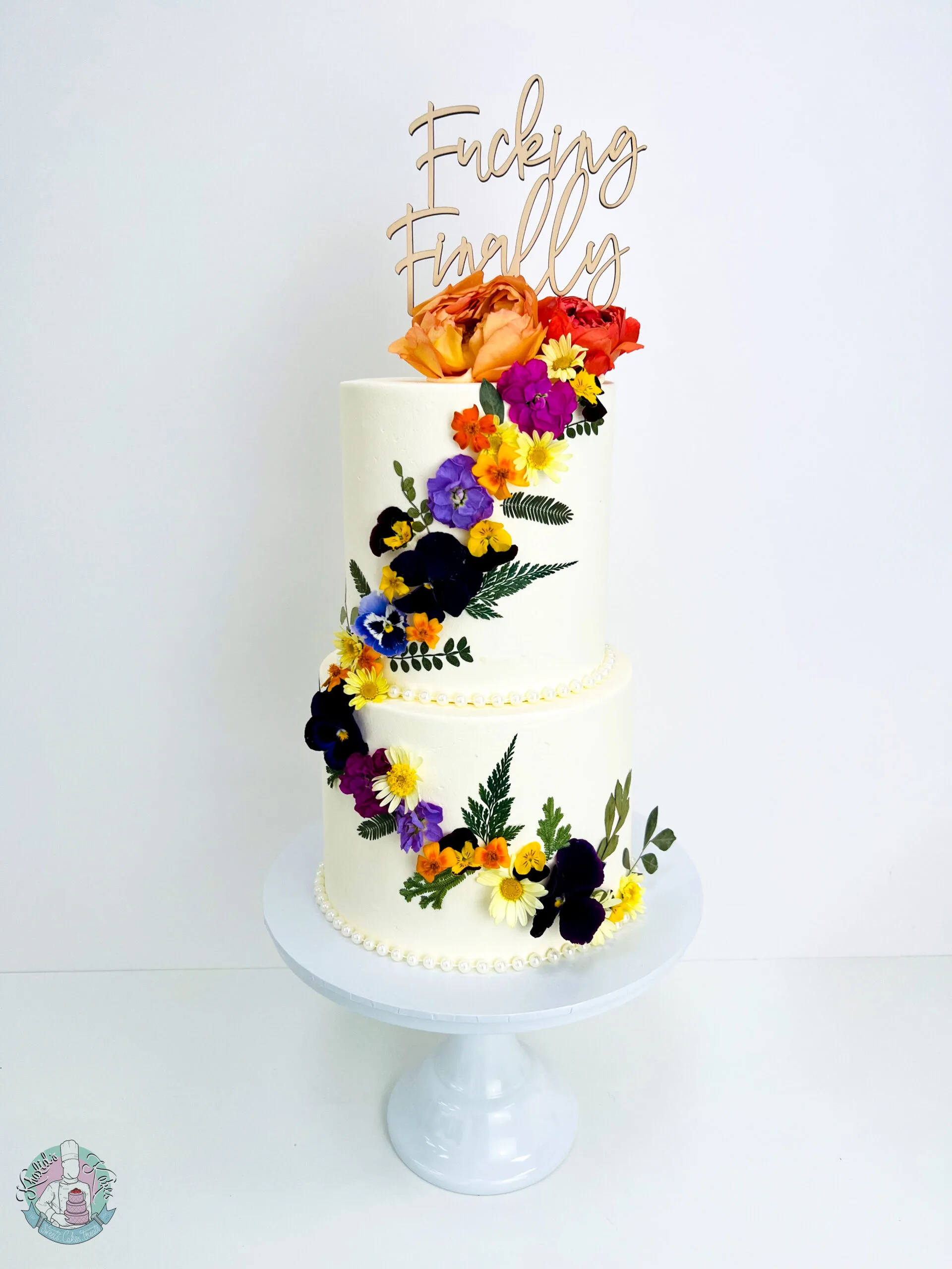Edible Flower Wedding Cake Birmingham — tiered cake decorated with real edible flowers and metallic leaf accents.