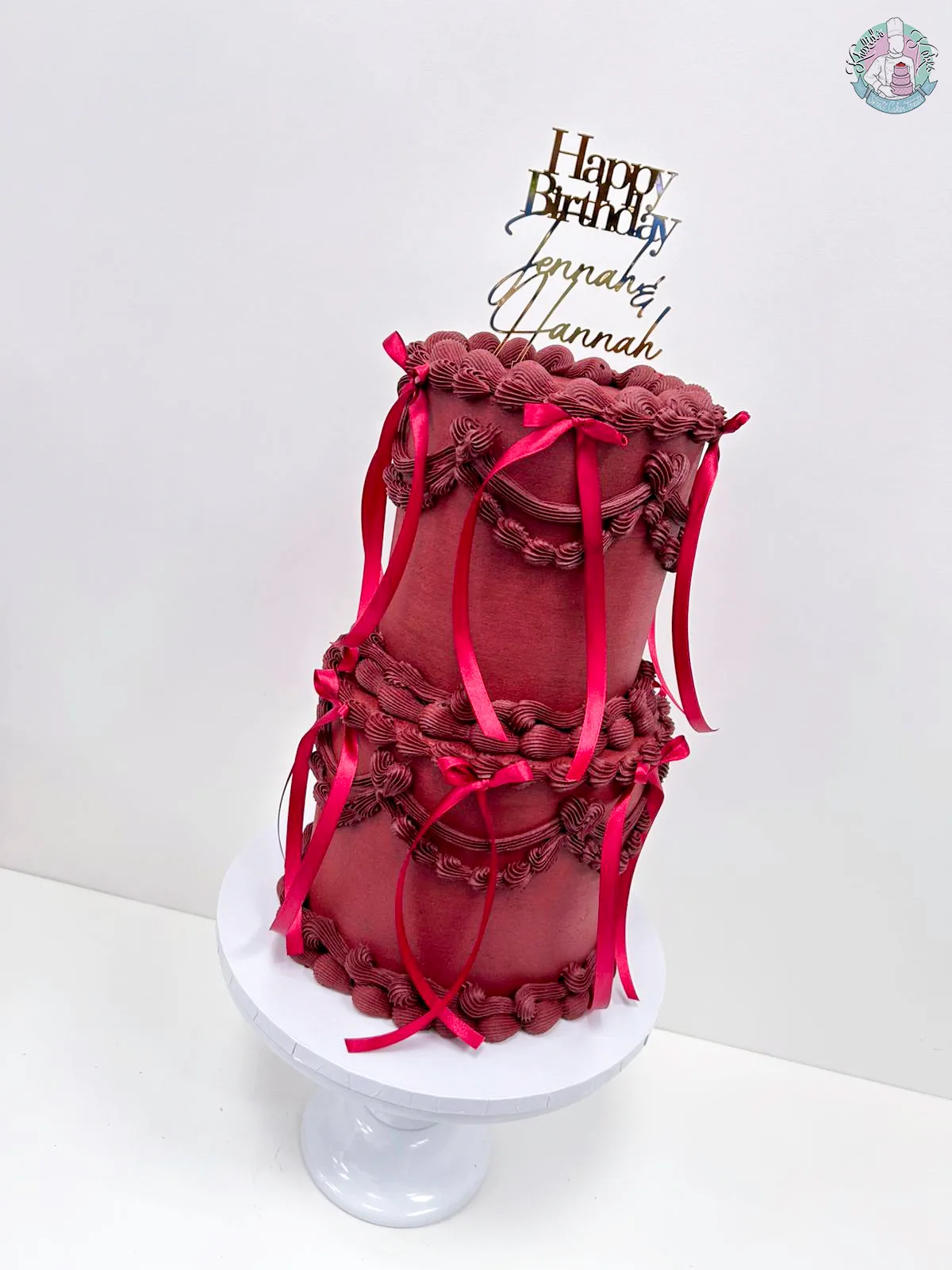 2 Tier Lambeth Cake Birmingham, an elegant two-tier cake with intricate Lambeth piping and a bow, handmade by Khalids Kakes