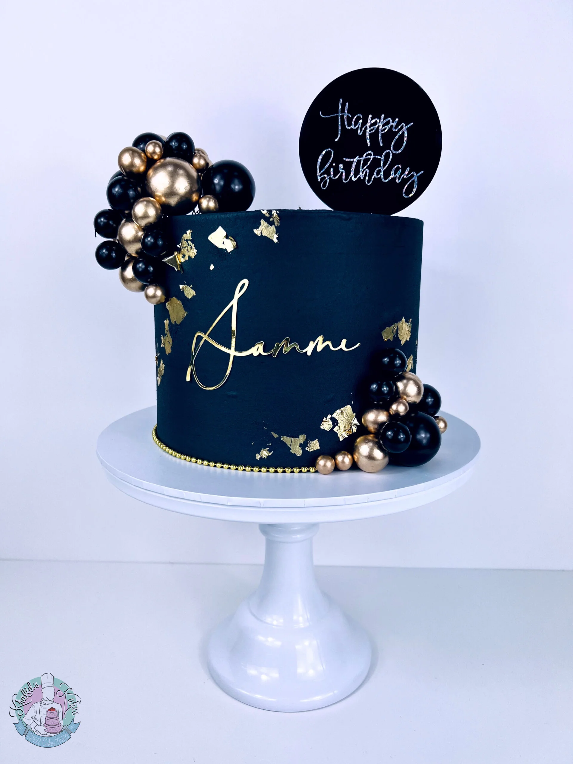 Black Cake Birmingham, a bold black celebration cake with metallic leaf detail, handmade by Khalids Kakes
