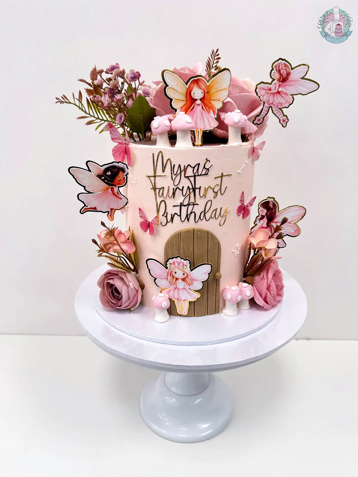 Fairy Cake 2 Birmingham — pink fairy-themed birthday cake with toadstools, fairy door, floral and butterfly details, handmade by Khalid's Kakes