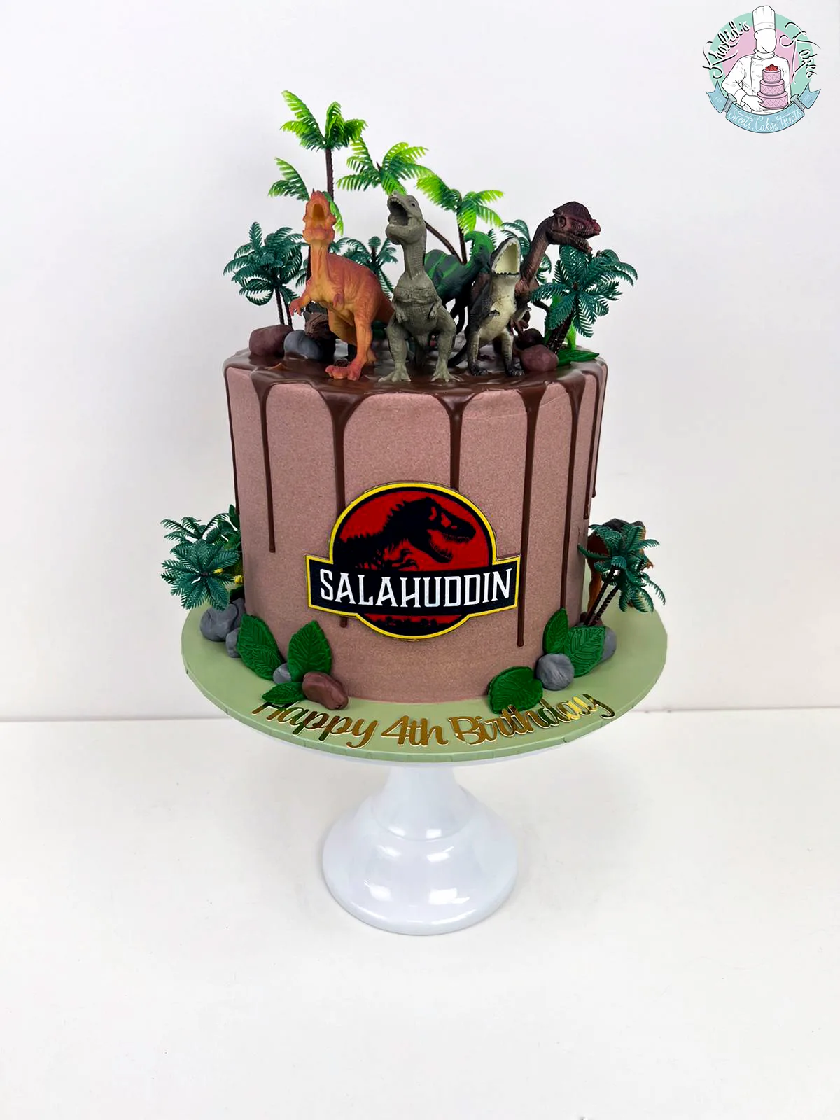 Jurassic Drip Cake Birmingham — children’s birthday cake with a chocolate drip and dinosaurs.