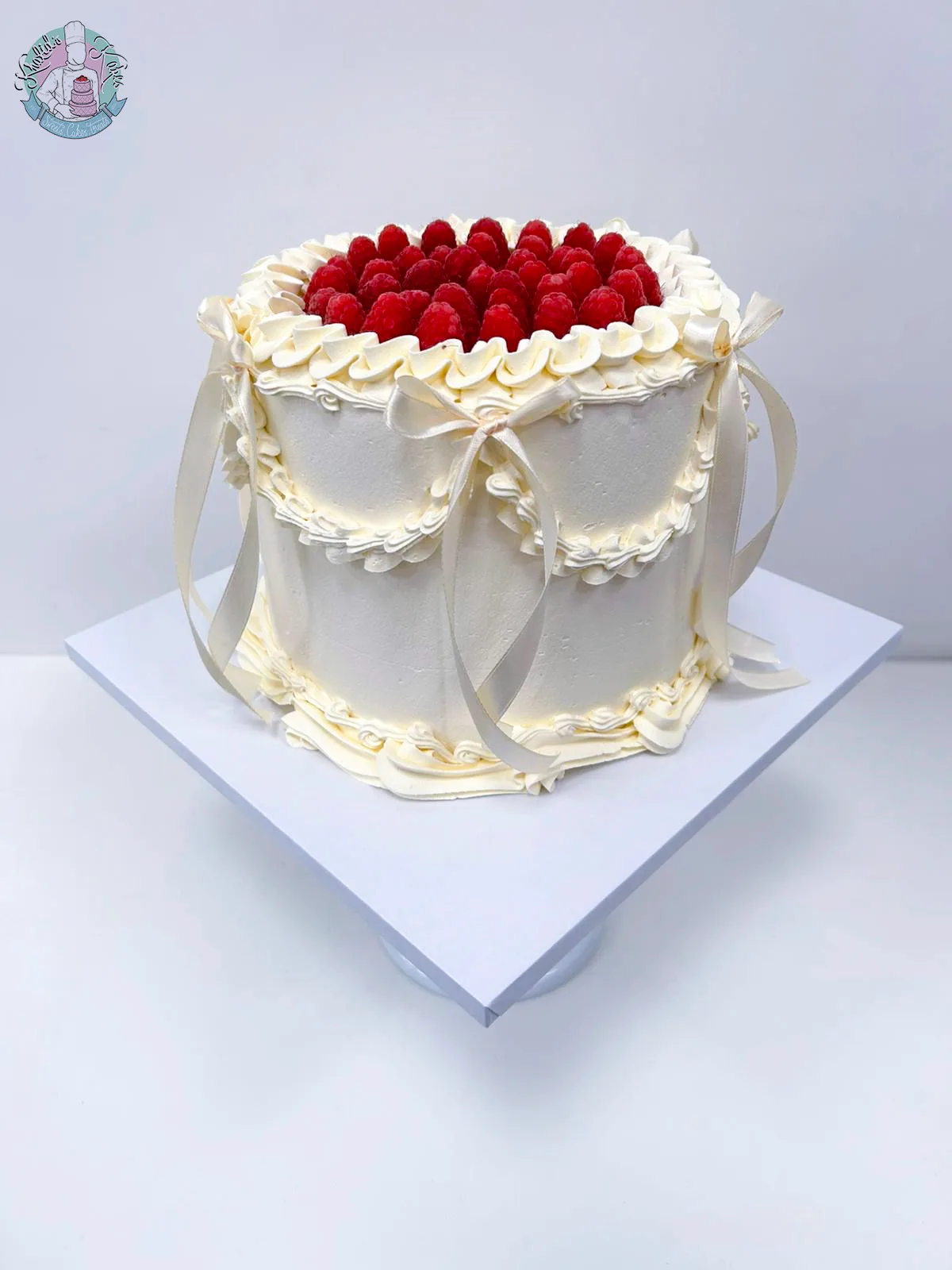 Vintage Raspberry Cake Birmingham, a piped buttercream cake with silk bows and fresh raspberries, handmade by Khalids Kakes