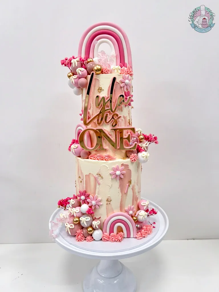 Rainbow 2 Tier Cake Birmingham — tall children’s birthday cake with bright rainbow bands and clouds.