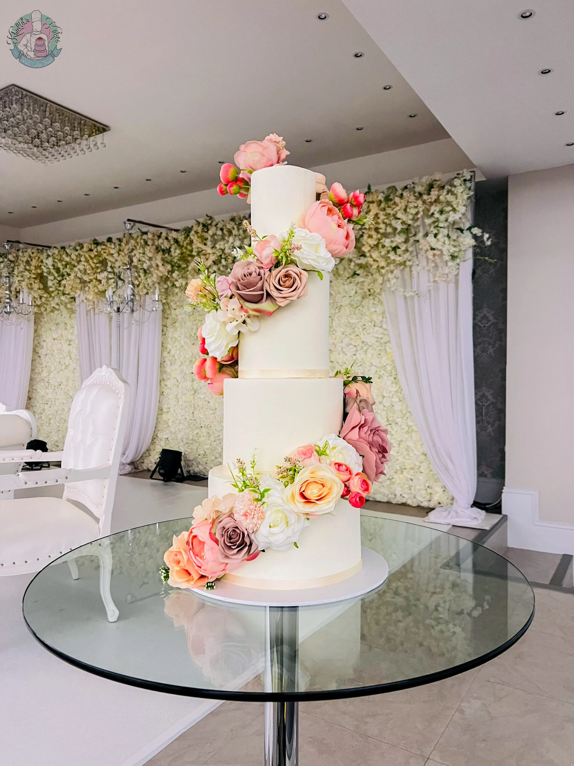 Spiral Wedding Cake Birmingham — tiered buttercream cake with a spiral of flowers winding around the tiers.