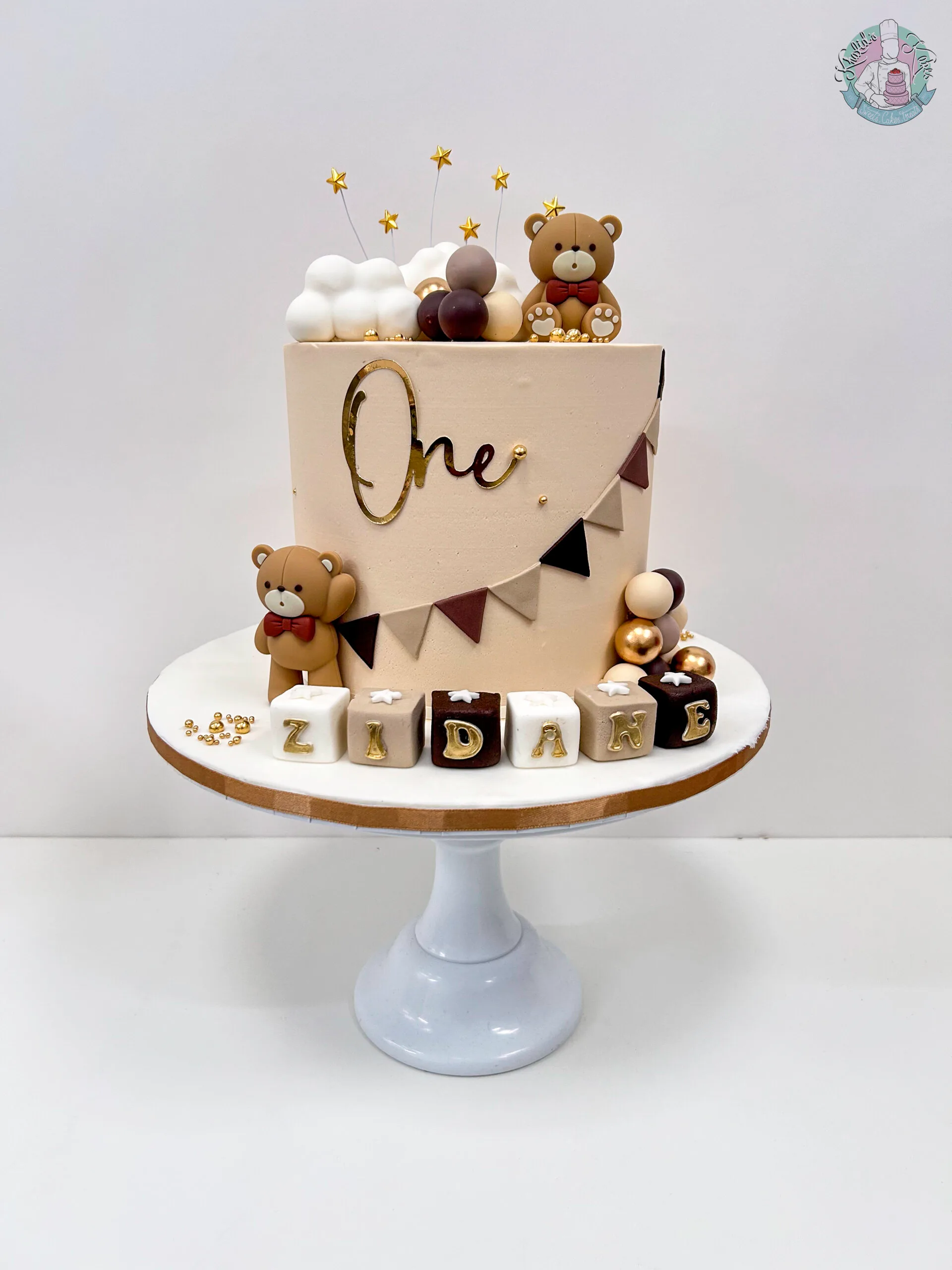 Teddy bear cake 3 Birmingham with sugar crafted decorations and non-edible teddies on vanilla buttercream, handmade by Khalid's Kakes