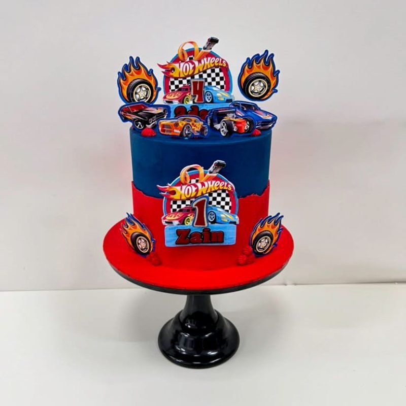 Hot Wheels Cake 2 Birmingham — bright red and blue racing cake with car toppers and checkered flag details, handmade by Khalid's Kakes