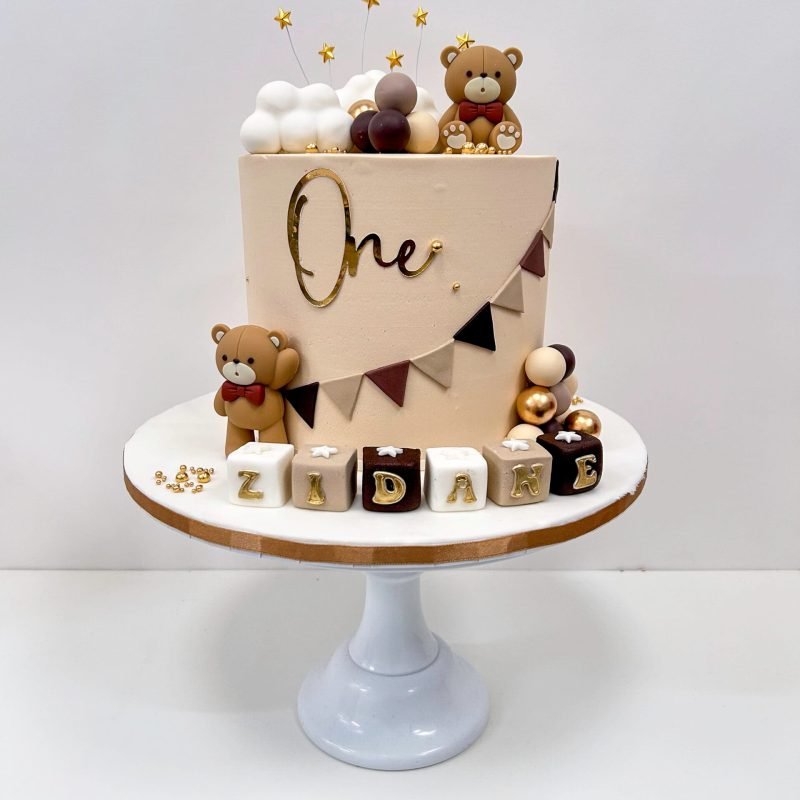 Teddy bear cake 3 Birmingham with sugar crafted decorations and non-edible teddies on vanilla buttercream, handmade by Khalid's Kakes
