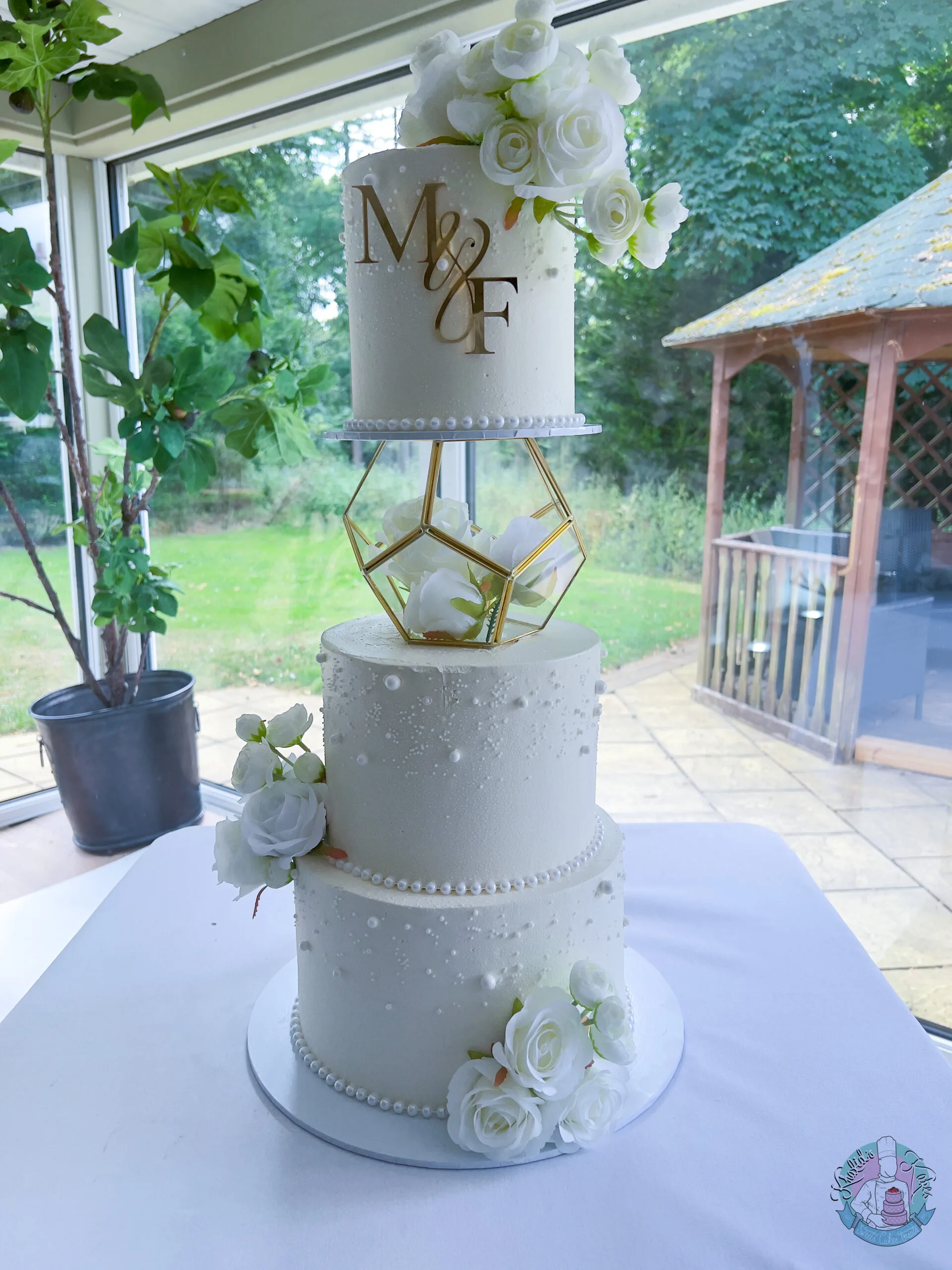 Pearl Hex Wedding Cake Birmingham — hexagonal tiered cake with soft pearl detailing and flower colour accents.