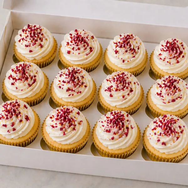 Shop 139 Raspberry Cupcakes Birmingham, a box of 12 white chocolate and raspberry cupcakes with vanilla buttercream and dried raspberries, by Khalids Kakes